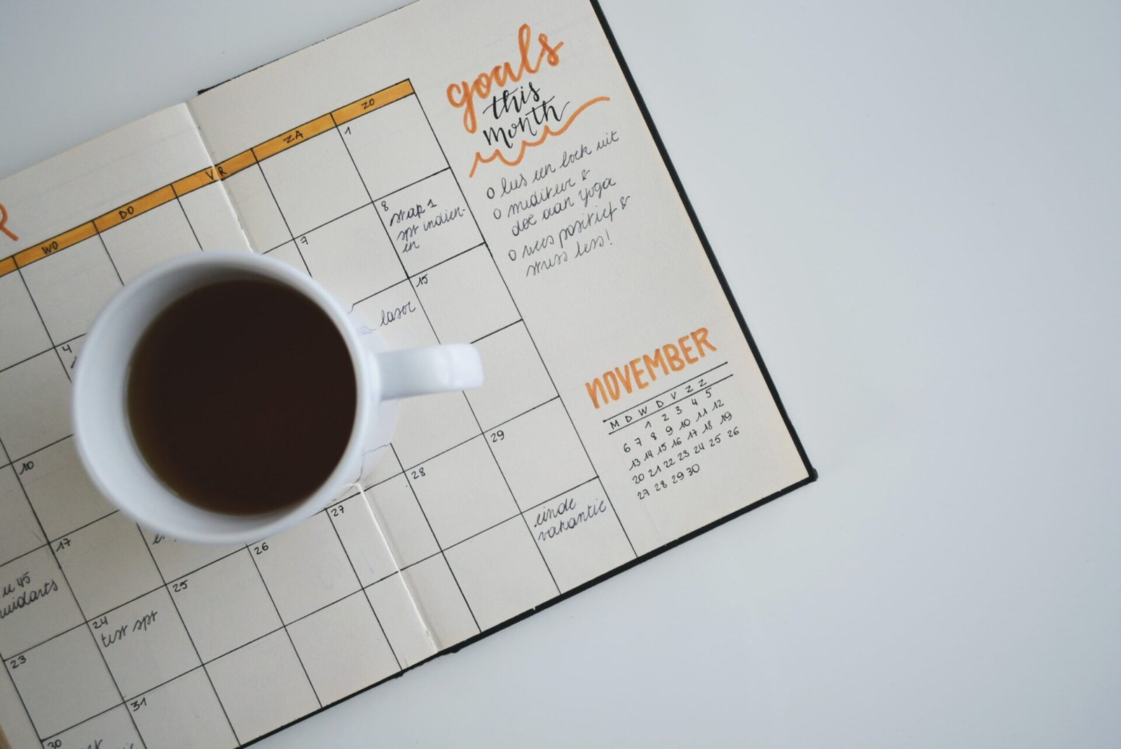 A cup of coffee over a calendar