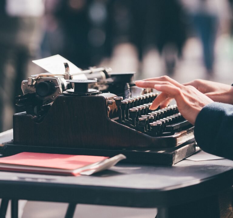 Hands typing on an old typewriter