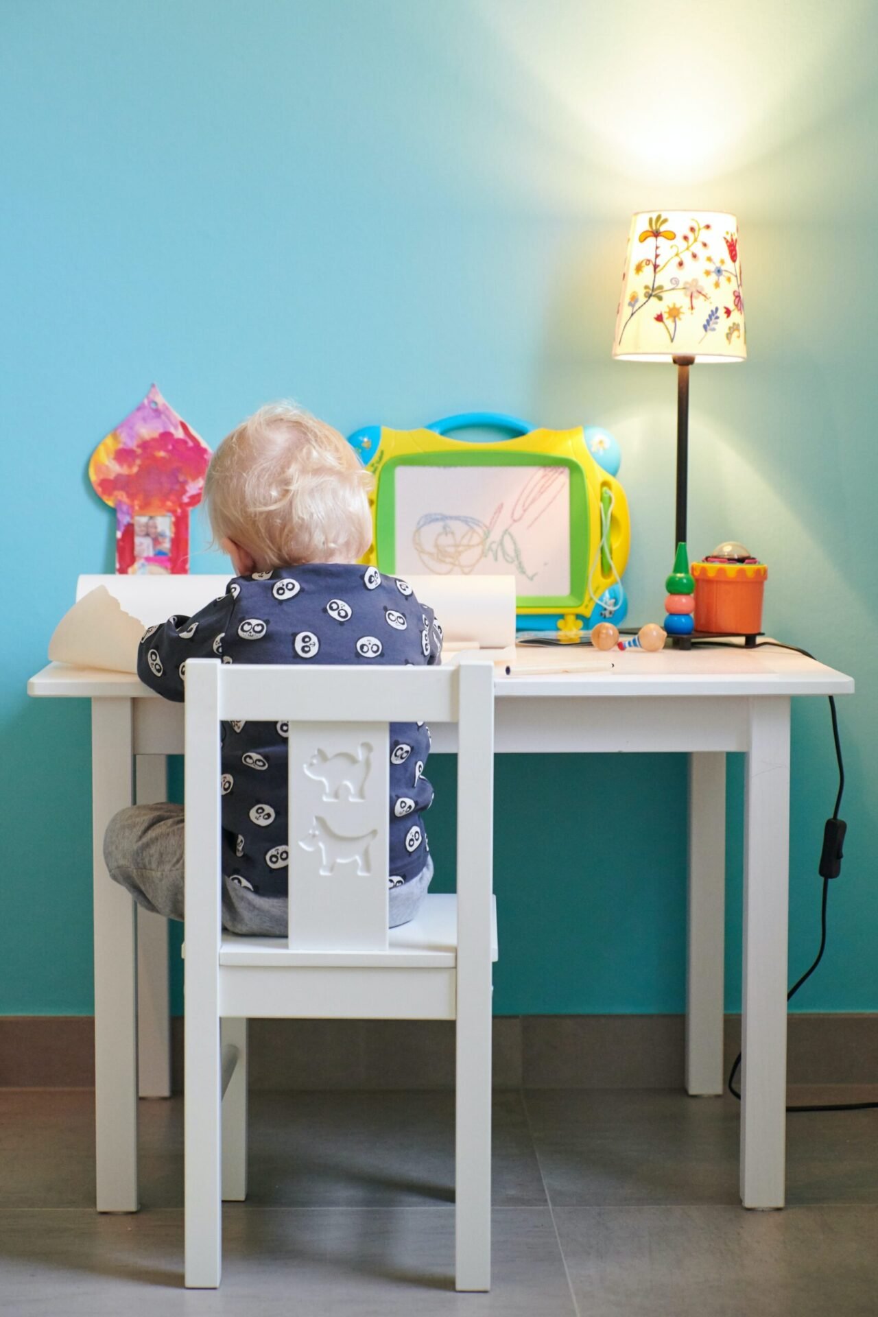 A baby drawing over a table