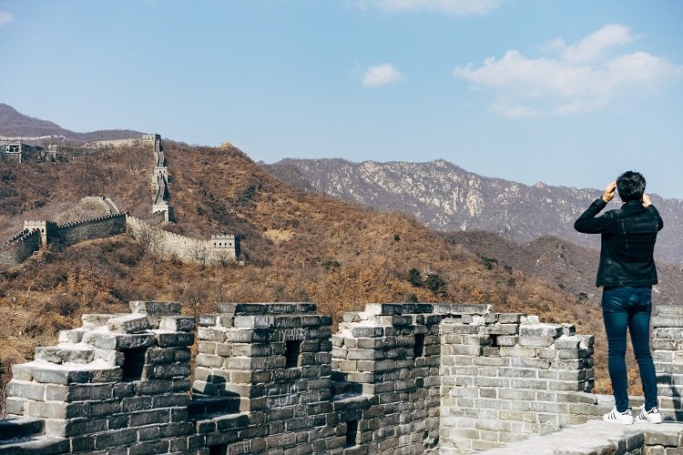 A man watching the horizon on the great wall of China