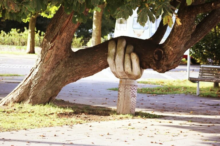 A hand statue holding a tree