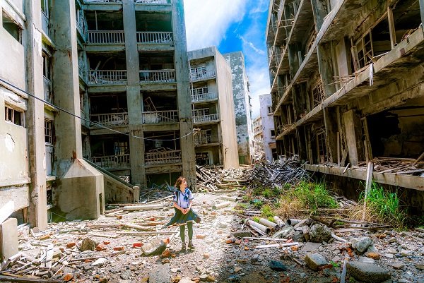 A woman is walking by ruined Nagasaki