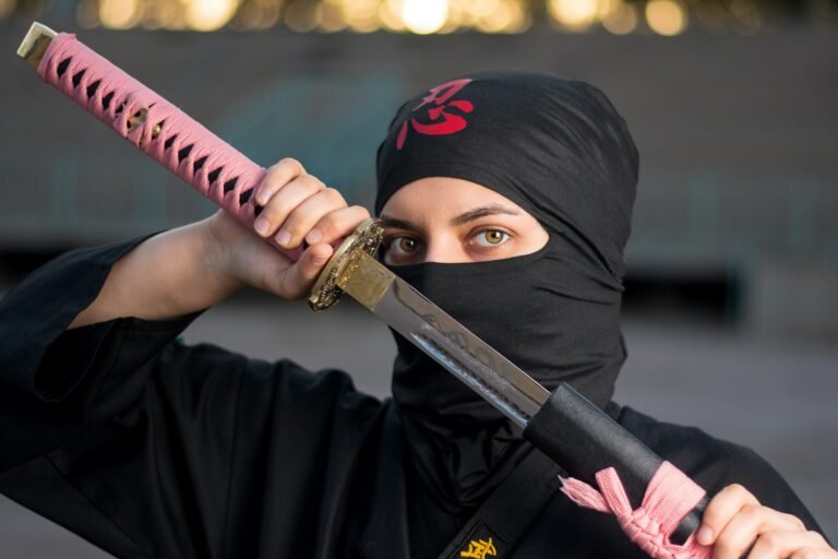 A woman ninja pulling a sword